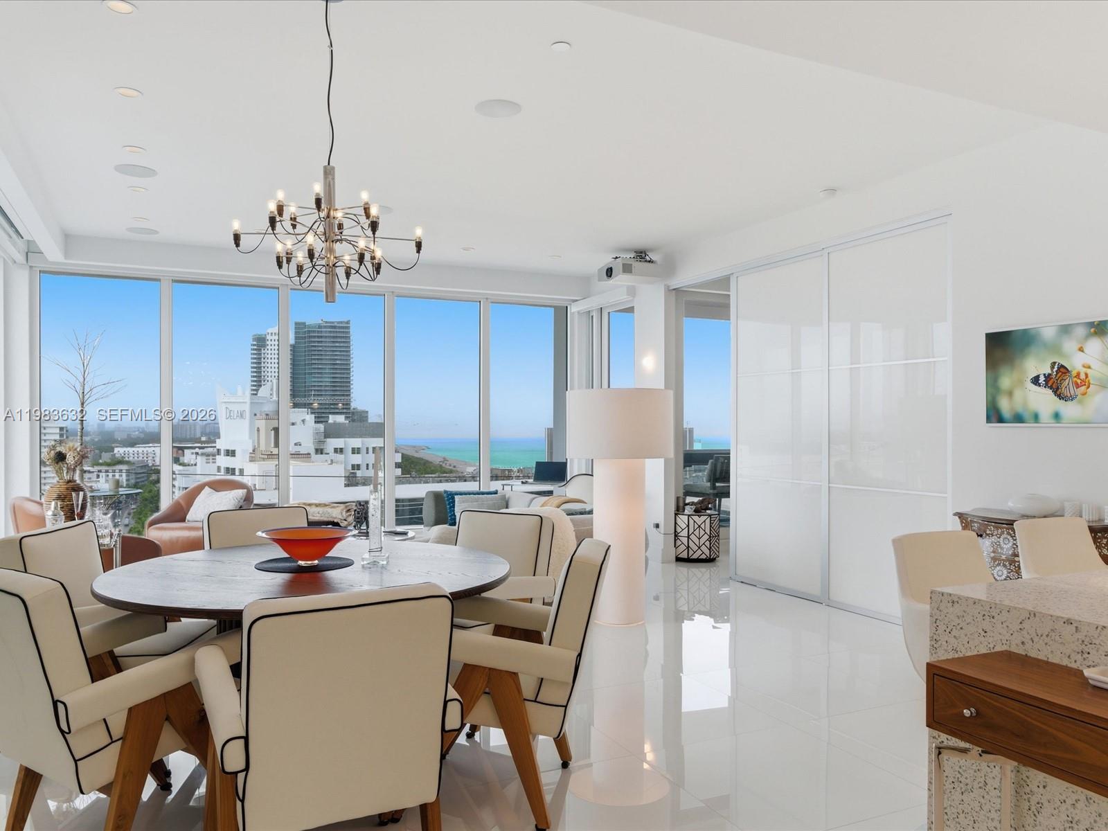 a view of a dining room with furniture and chandelier