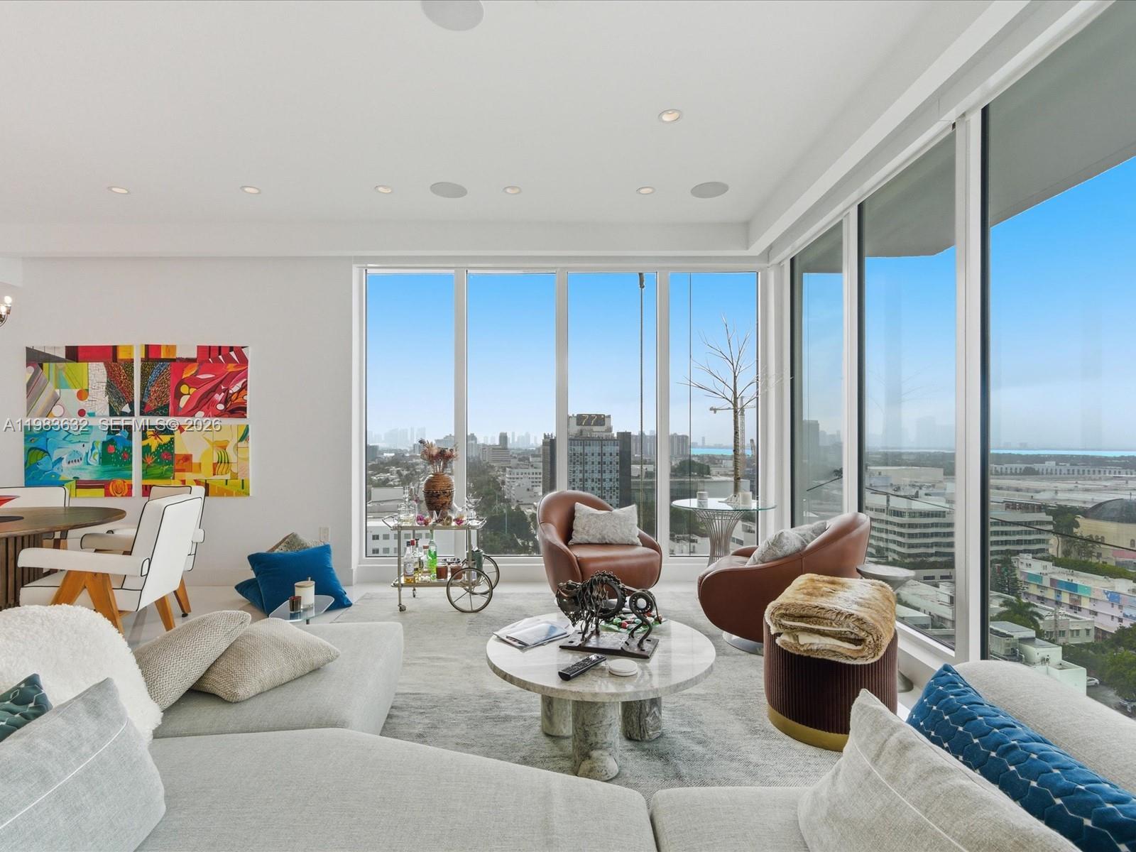 100 Lincoln Road, Unit PH10 Miami Beach, FL 33139 - Photo 2 of 33 a living room with furniture and a floor to ceiling window