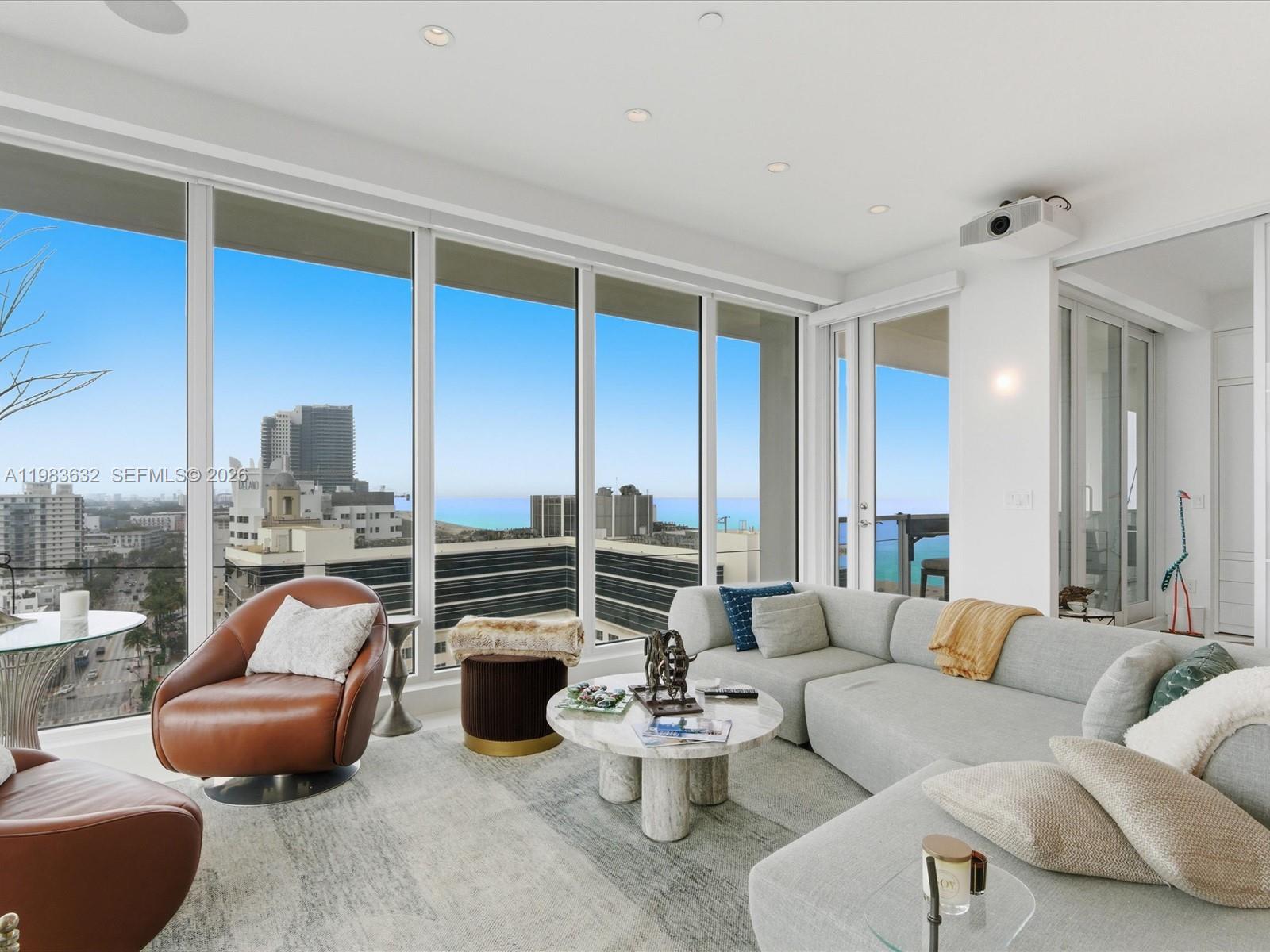 100 Lincoln Road, Unit PH10 Miami Beach, FL 33139 - Photo 3 of 33 a living room with furniture a rug and a large window