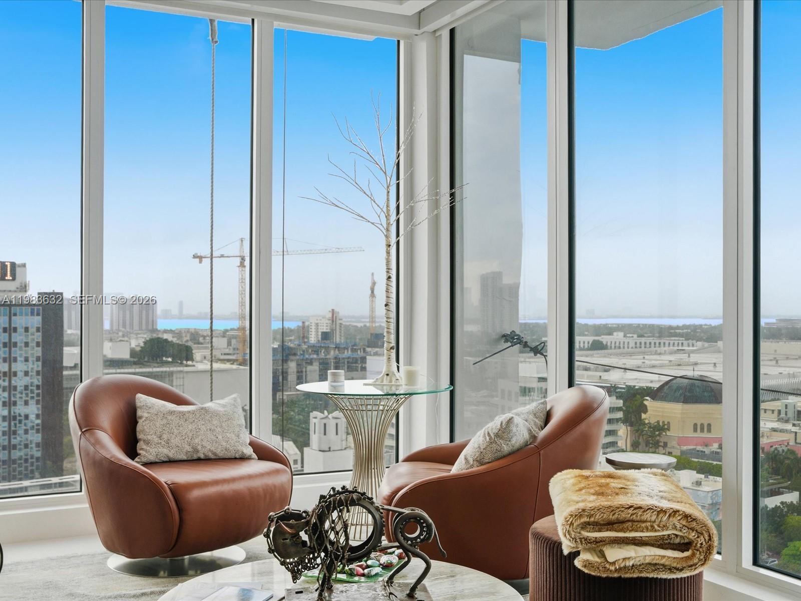 100 Lincoln Road, Unit PH10 Miami Beach, FL 33139 - Photo 5 of 33 a living room with furniture and a floor to ceiling window