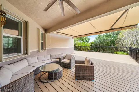 a view of an outdoor dining space with furniture and garden view