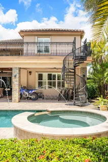 a view of swimming pool with outdoor seating and plants