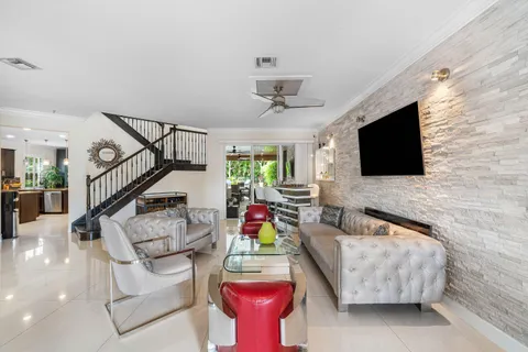 a kitchen with stainless steel appliances granite countertop a stove a sink a oven a dining table and chairs