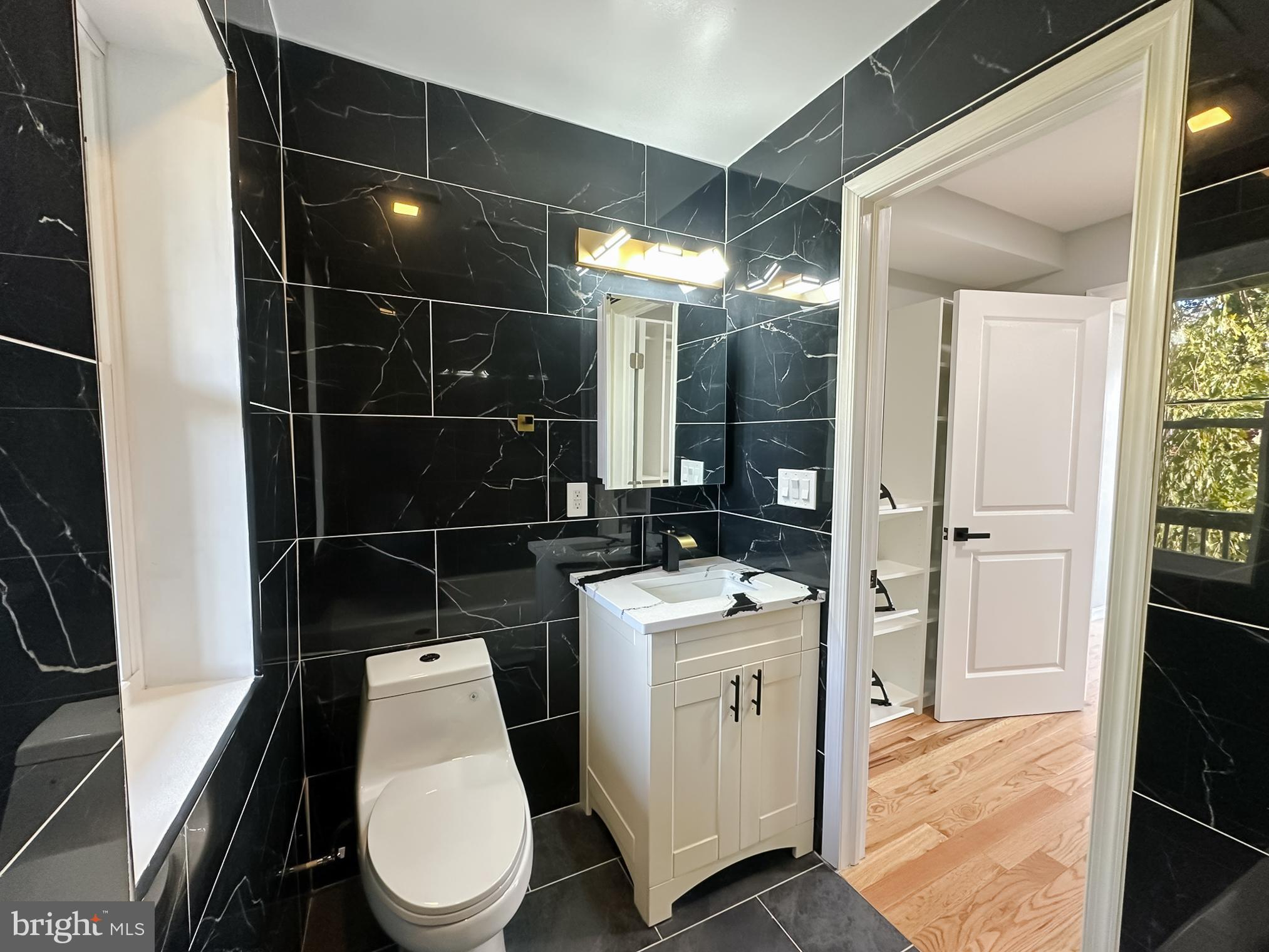 504 North Schroeder Street Baltimore, MD 21223 - Photo 15 of 31 a bathroom with a toilet a sink and shower