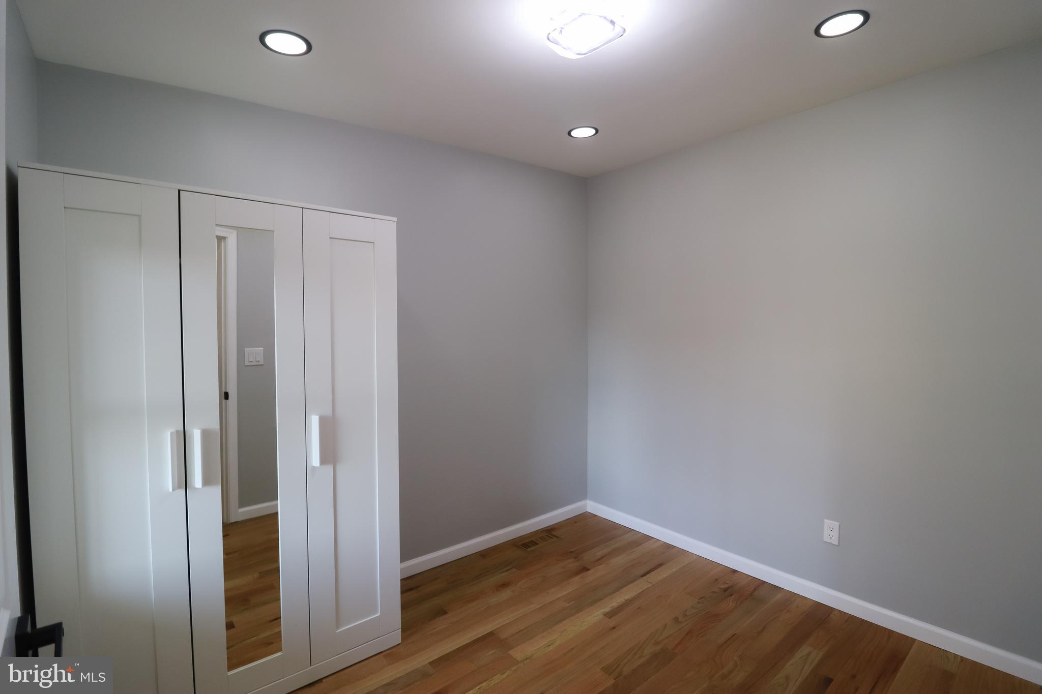 504 North Schroeder Street Baltimore, MD 21223 - Photo 19 of 31 a view of an empty room with wooden floor and closet