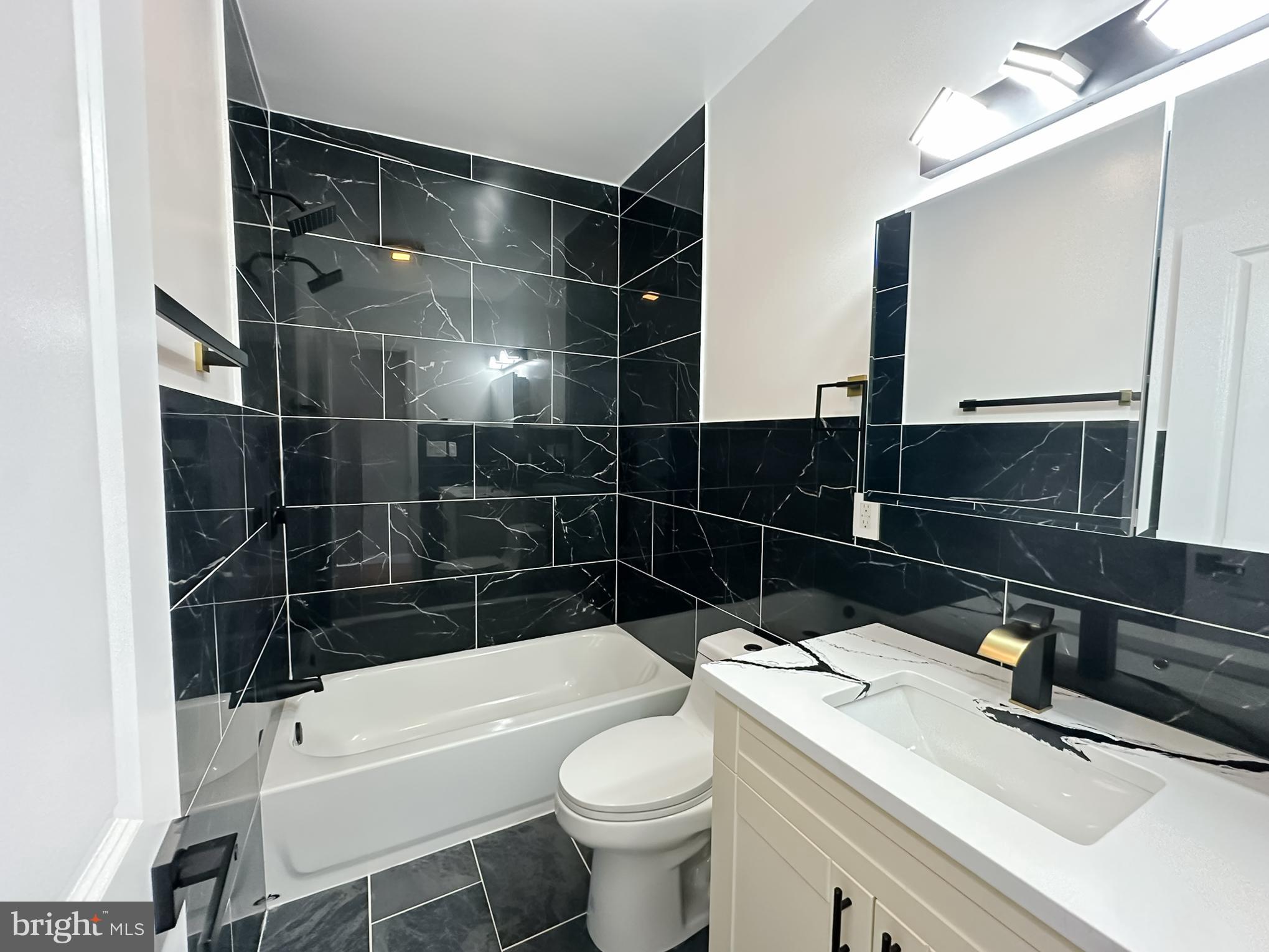 504 North Schroeder Street Baltimore, MD 21223 - Photo 21 of 31 a bathroom with a sink toilet and shower