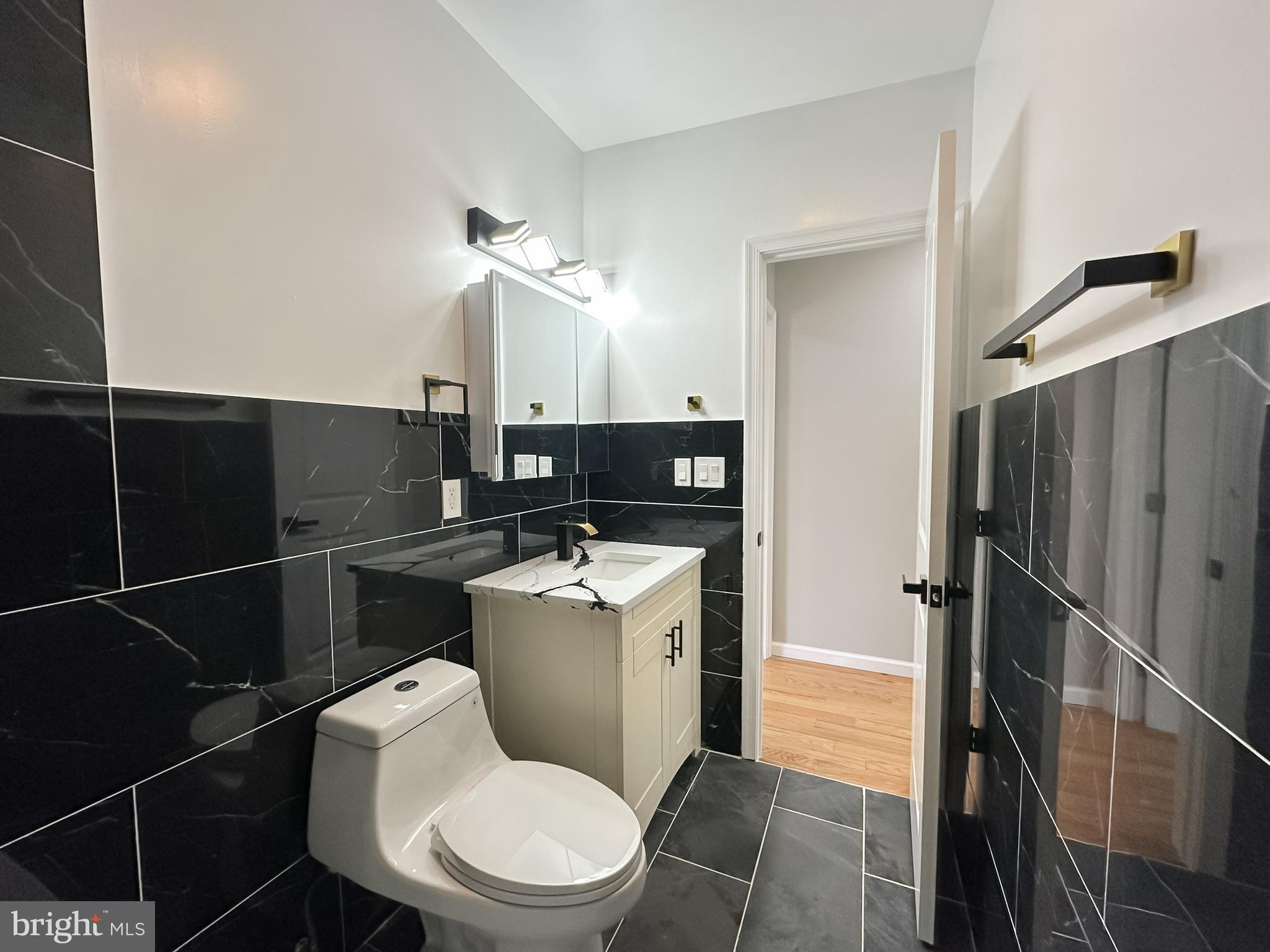 504 North Schroeder Street Baltimore, MD 21223 - Photo 22 of 31 a bathroom with a toilet a sink and a shower