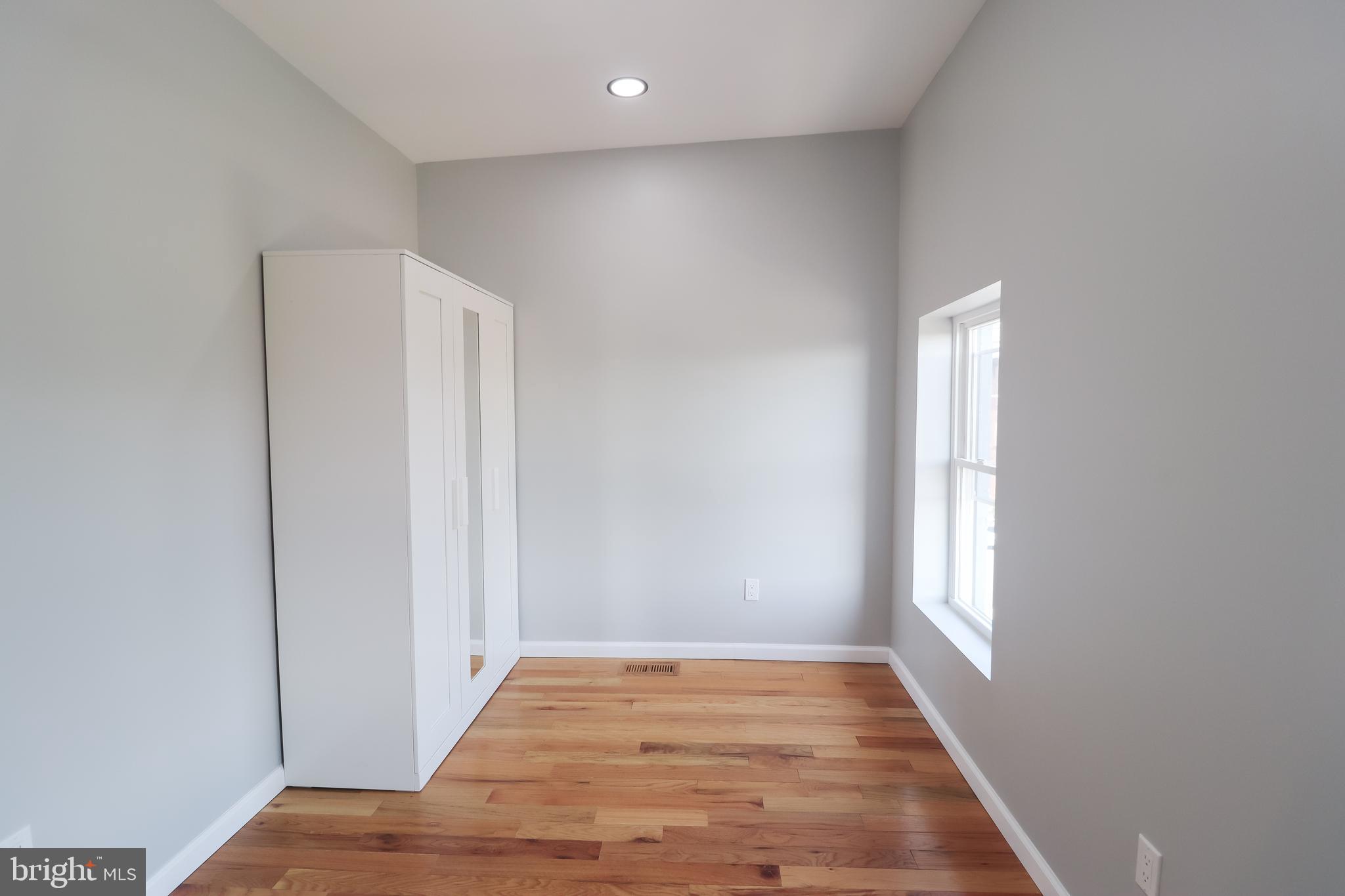 504 North Schroeder Street Baltimore, MD 21223 - Photo 23 of 31 a view of hallway with window and wooden floor