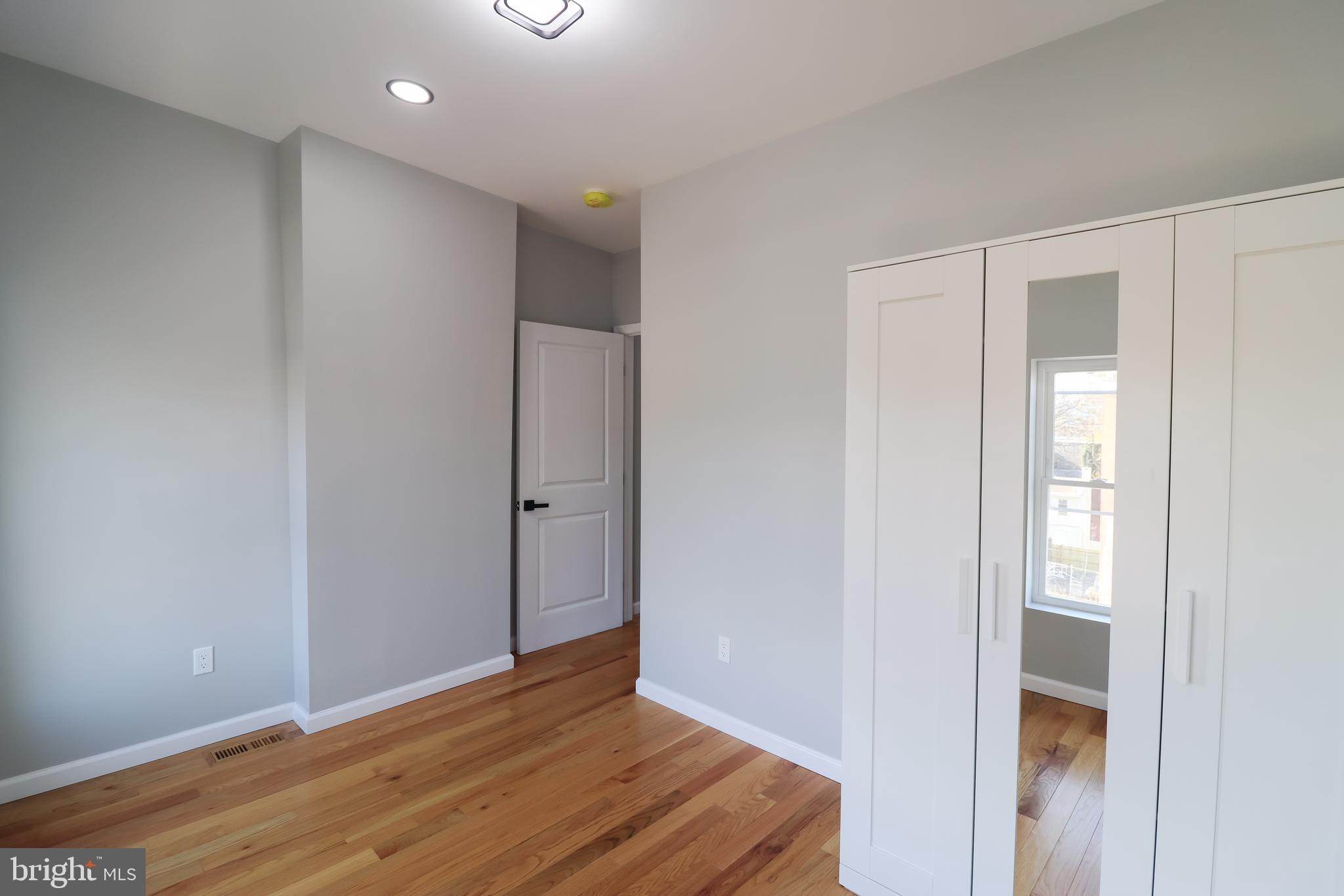 504 North Schroeder Street Baltimore, MD 21223 - Photo 24 of 31 a view of an empty room with wooden floor