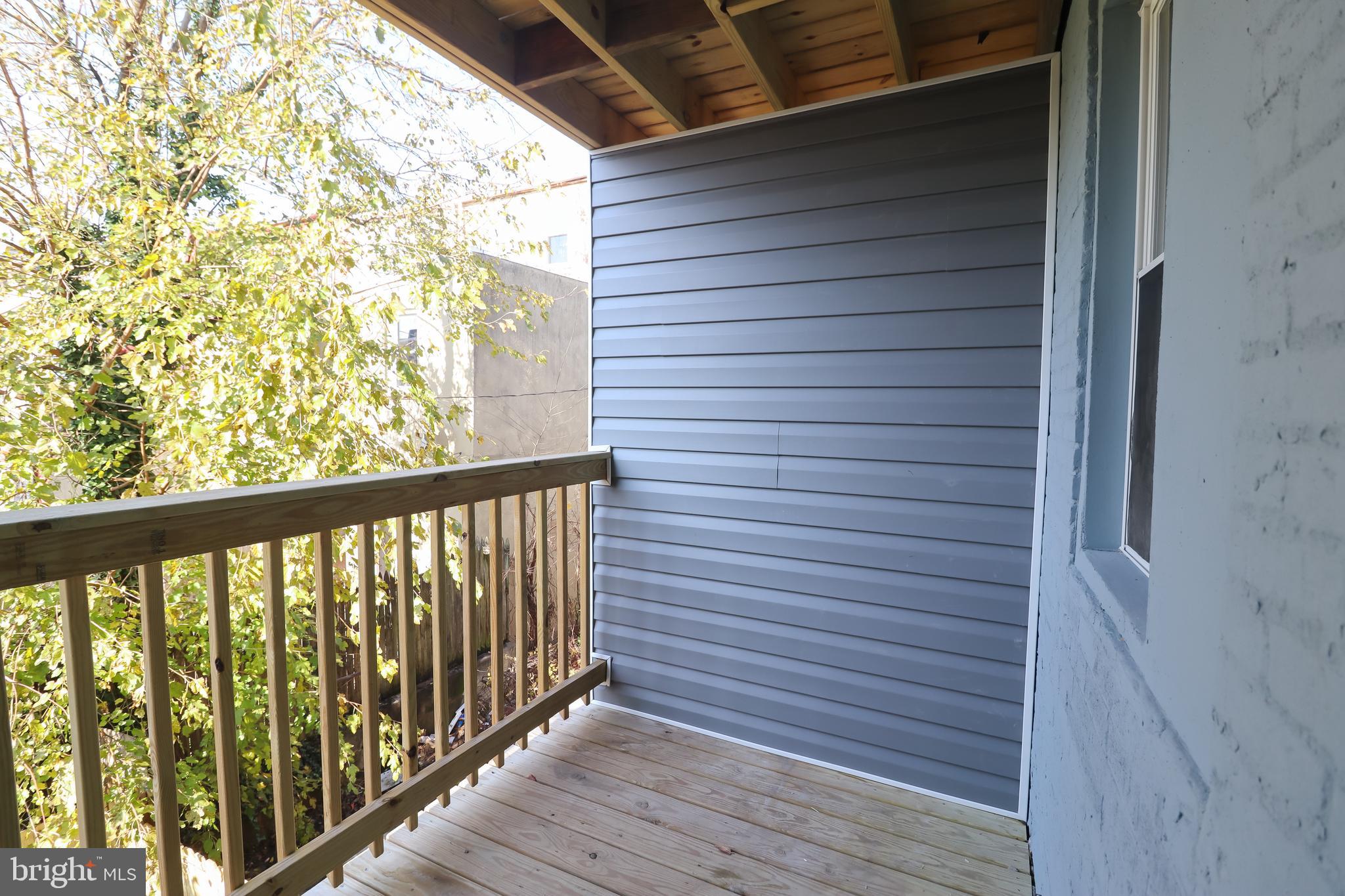 504 North Schroeder Street Baltimore, MD 21223 - Photo 9 of 31 a view of a balcony with wooden floor