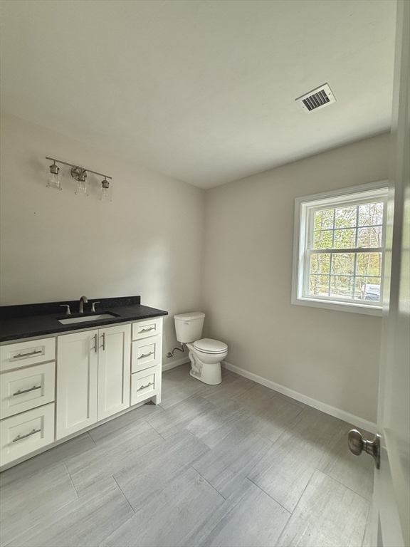 1 A Dudley Road Townsend, MA 01469 - Photo 13 of 17 a spacious bathroom with a toilet sink and a mirror