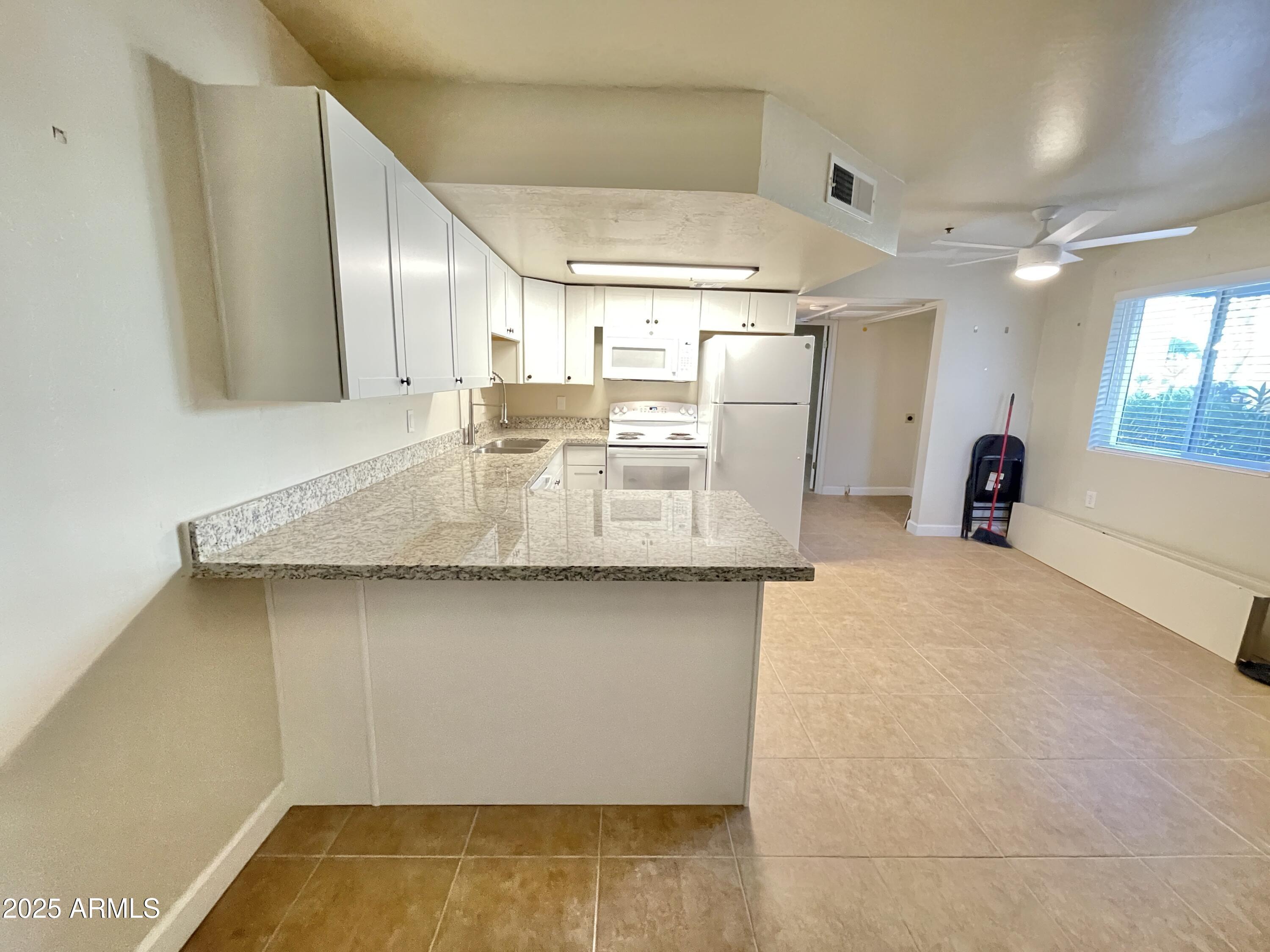 12221 West Bell Road, Unit 162 Surprise, AZ 85378 - Photo 2 of 36 Kitchen View 1