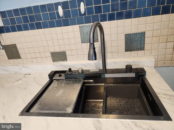 a view of a kitchen with a sink and a window
