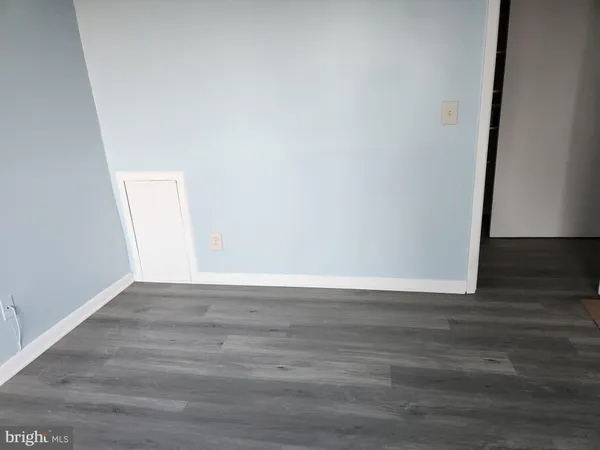 a view of a kitchen with wooden floor and a sink