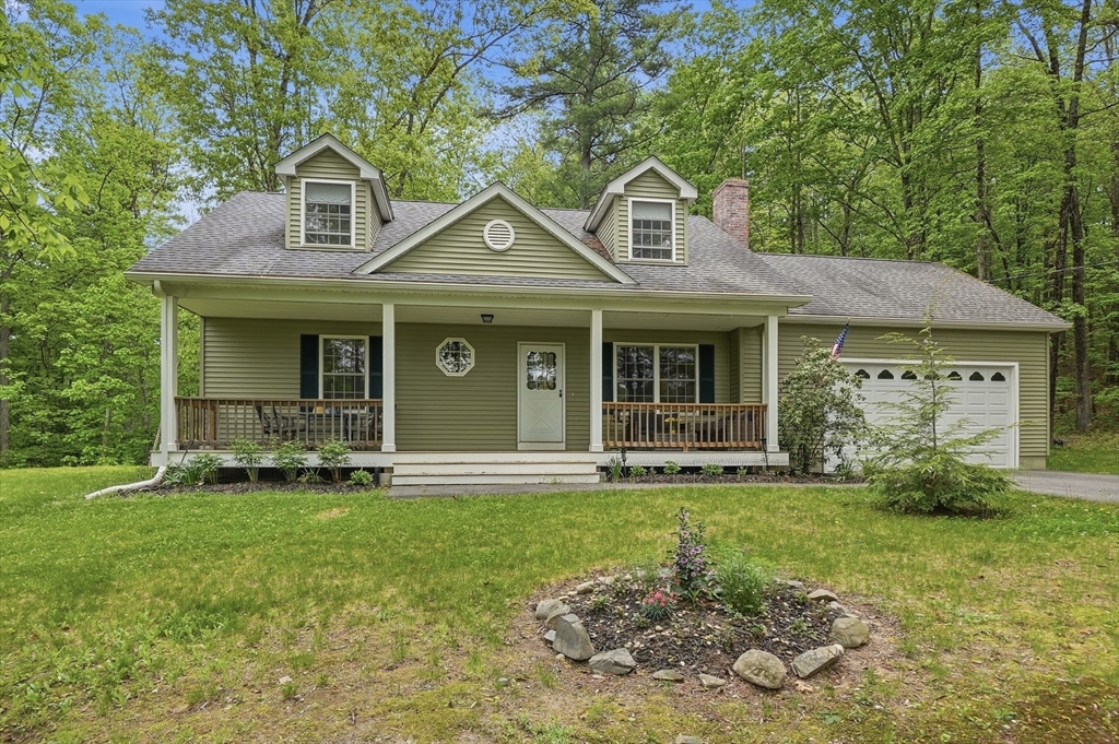 186 Common Street Groton, MA 01450 - Photo 2 of 28 a front view of a house with garden