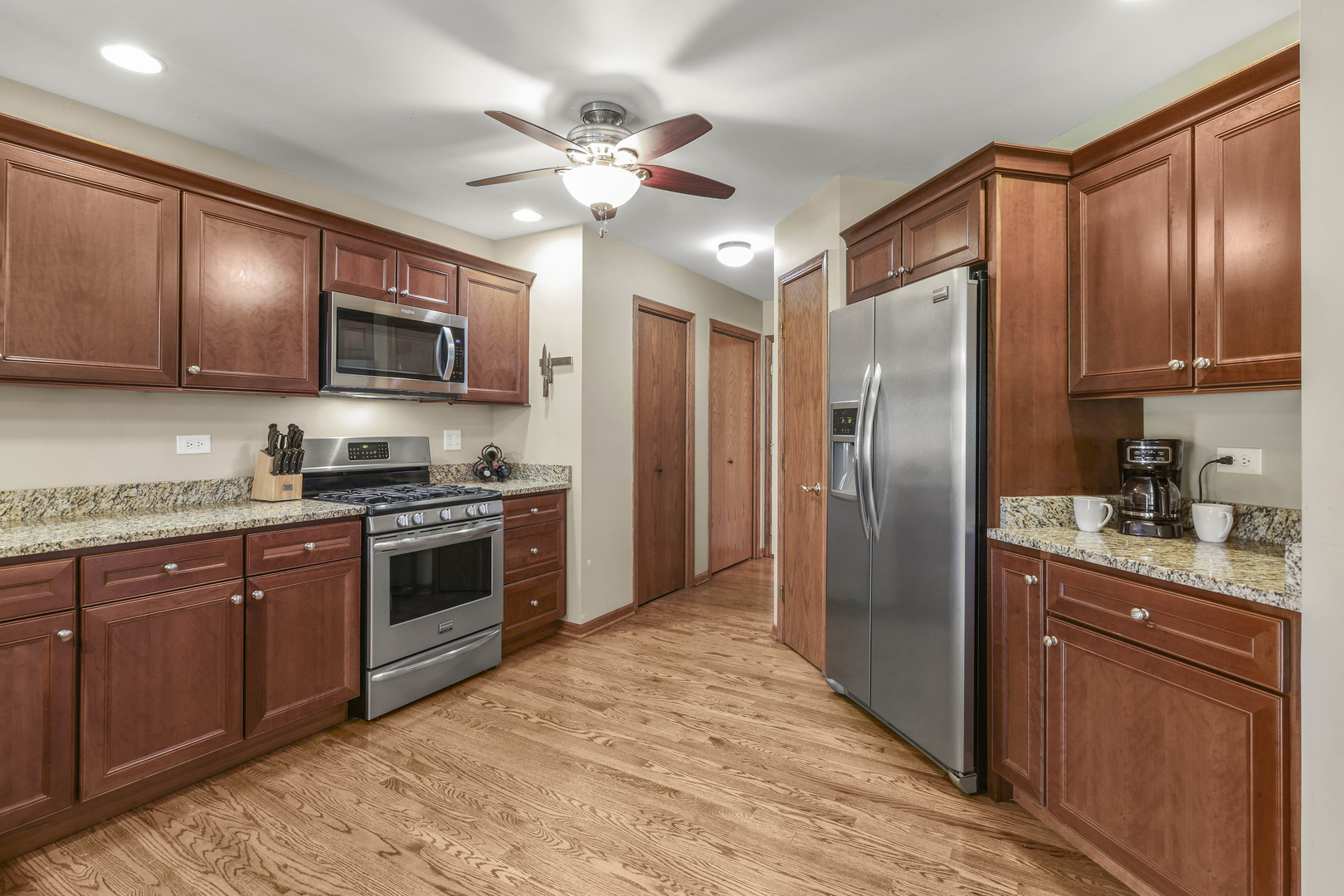 173 Harper Lane Lemont, IL 60439 - Photo 16 of 36 a kitchen with stainless steel appliances granite countertop a stove refrigerator and cabinets