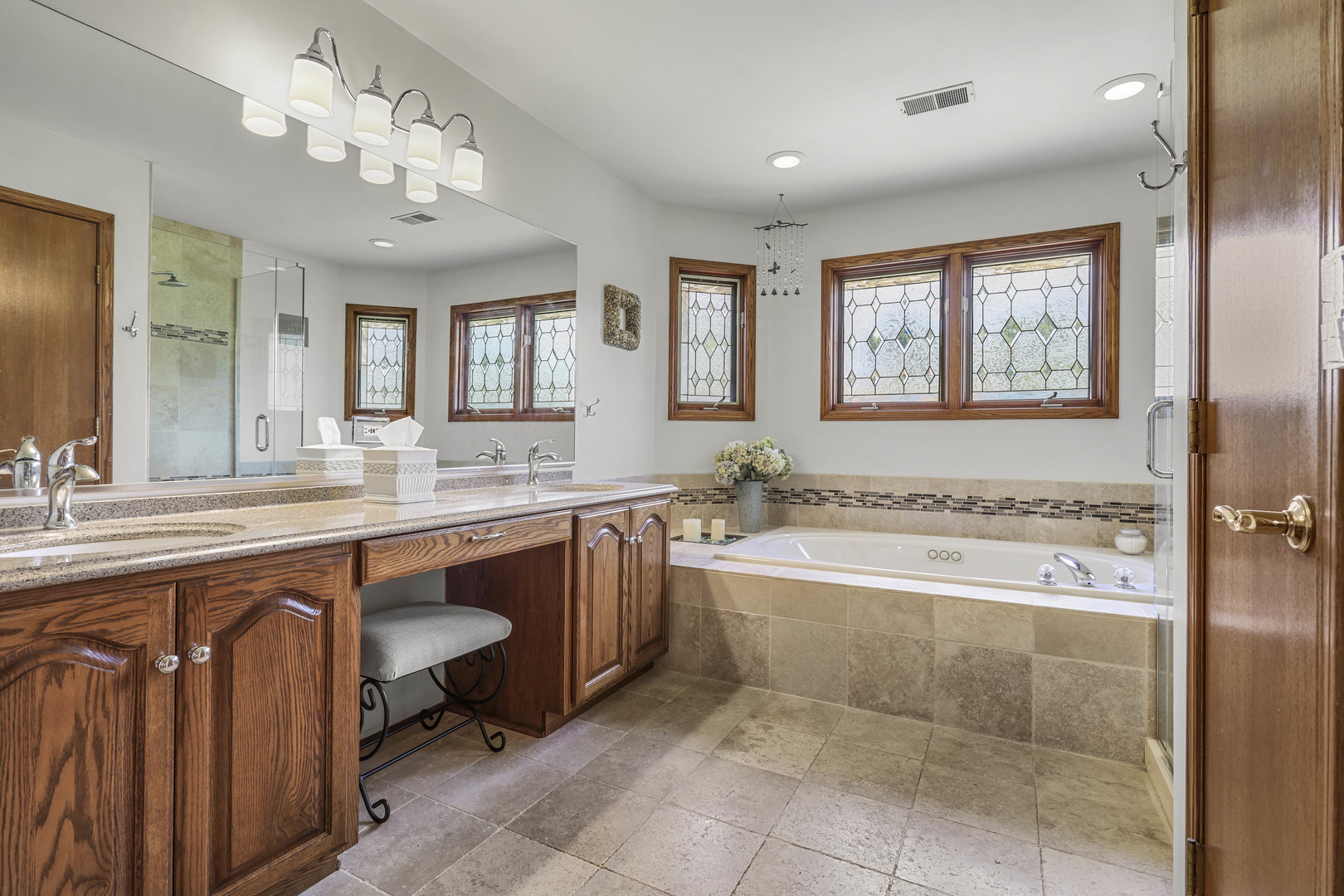 173 Harper Lane Lemont, IL 60439 - Photo 22 of 36 a spacious bathroom with a granite countertop sink a large mirror and a bathtub