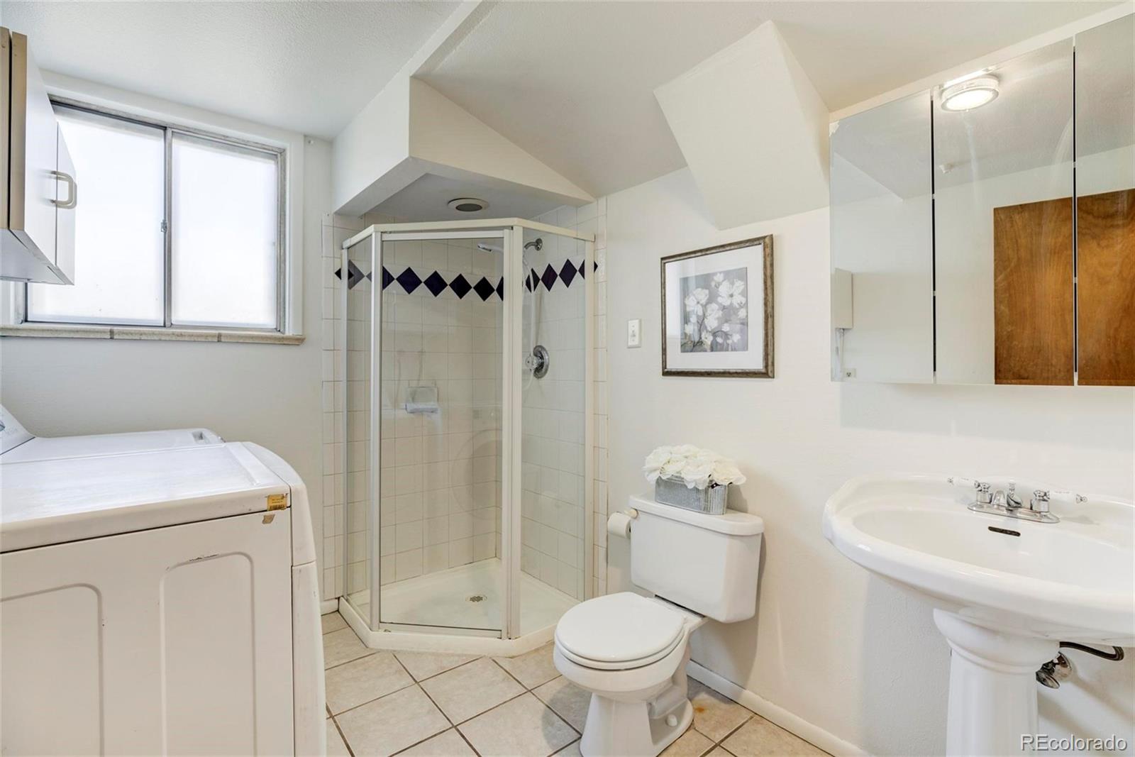3170 Wright Street Wheat Ridge, CO 80215 - Photo 27 of 29 a bathroom with a sink toilet and shower