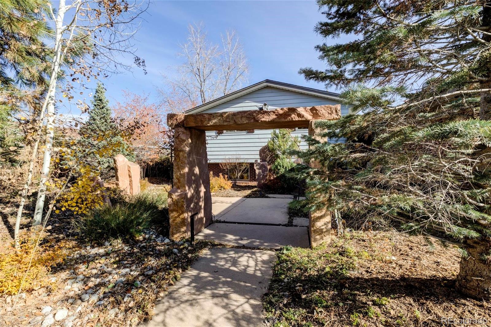 3170 Wright Street Wheat Ridge, CO 80215 - Photo 4 of 29 a front view of a house with a yard