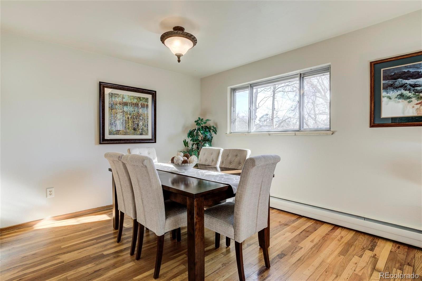 3170 Wright Street Wheat Ridge, CO 80215 - Photo 10 of 29 a view of a dining room with furniture window and wooden floor
