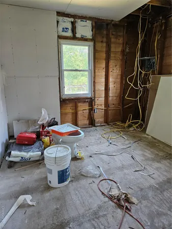 a living room with furniture a air conditioner vent and a window