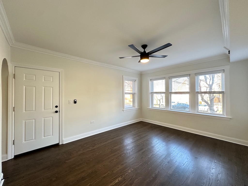 3045 West Addison Street, Unit 1 Chicago, IL 60618 - Photo 11 of 20 an empty room with wooden floor and windows