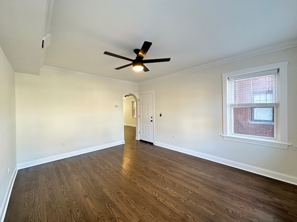 3045 West Addison Street, Unit 1 Chicago, IL 60618 - Photo 12 of 20 wooden floor in an empty room with a window