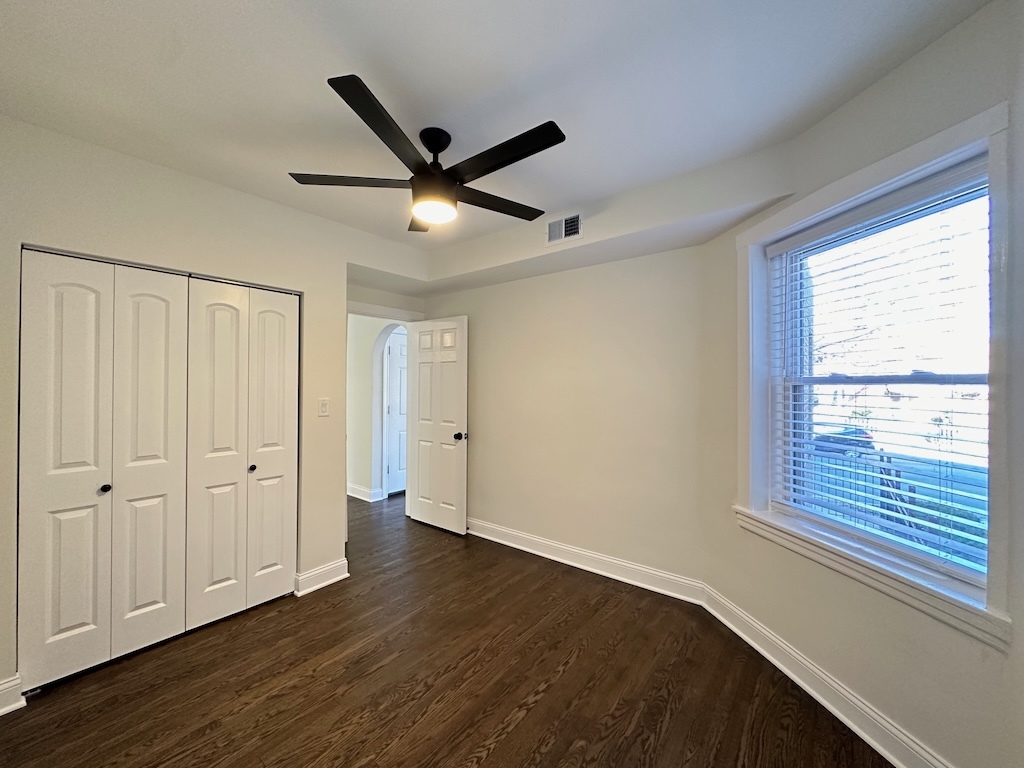 3045 West Addison Street, Unit 1 Chicago, IL 60618 - Photo 15 of 20 a view of an empty room with wooden floor and a window