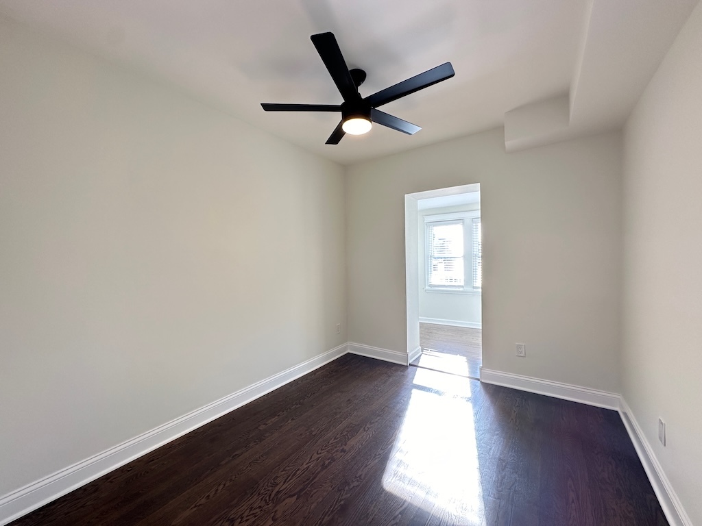 3045 West Addison Street, Unit 1 Chicago, IL 60618 - Photo 16 of 20 an empty room with wooden floor and windows