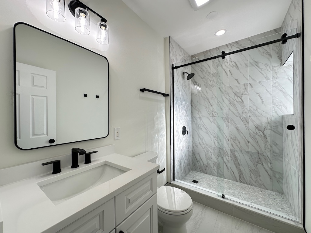 3045 West Addison Street, Unit 1 Chicago, IL 60618 - Photo 19 of 20 a bathroom with a sink a toilet and shower