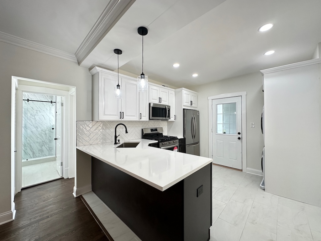 3045 West Addison Street, Unit 1 Chicago, IL 60618 - Photo 2 of 20 a kitchen with a refrigerator a sink and cabinets