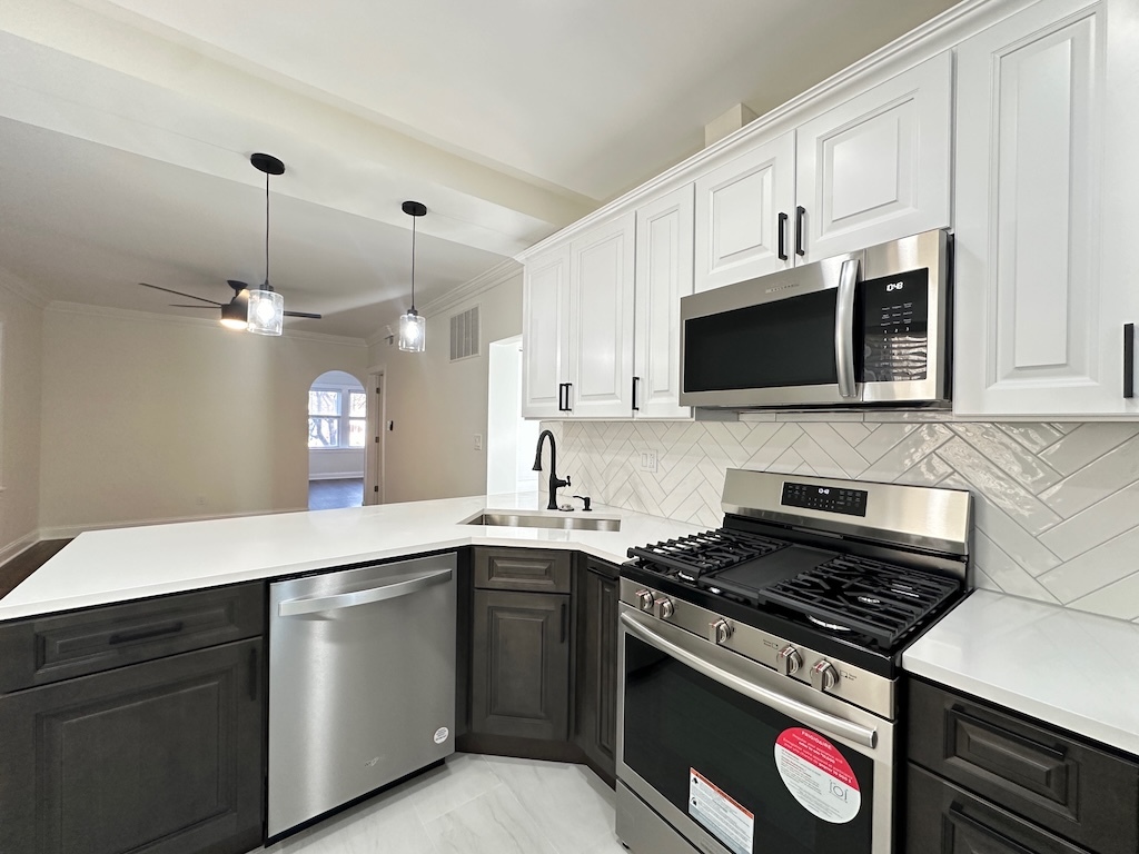 3045 West Addison Street, Unit 1 Chicago, IL 60618 - Photo 5 of 20 a kitchen with a sink stove and microwave