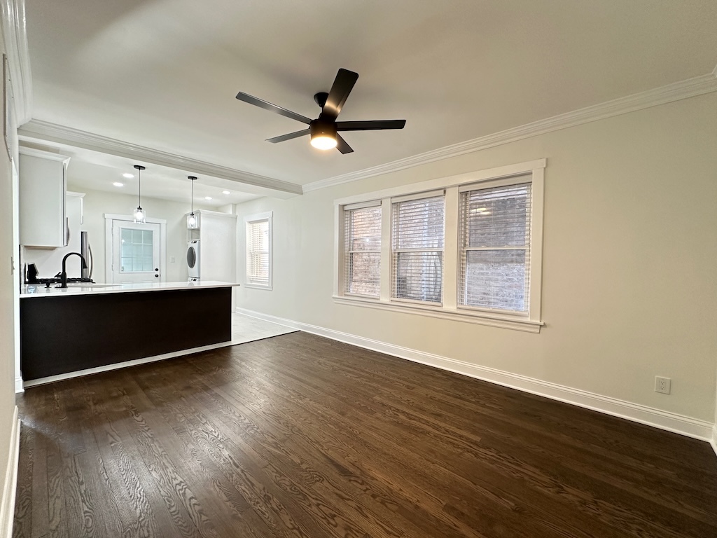 3045 West Addison Street, Unit 1 Chicago, IL 60618 - Photo 7 of 20 a view of an empty room with wooden floor and a window