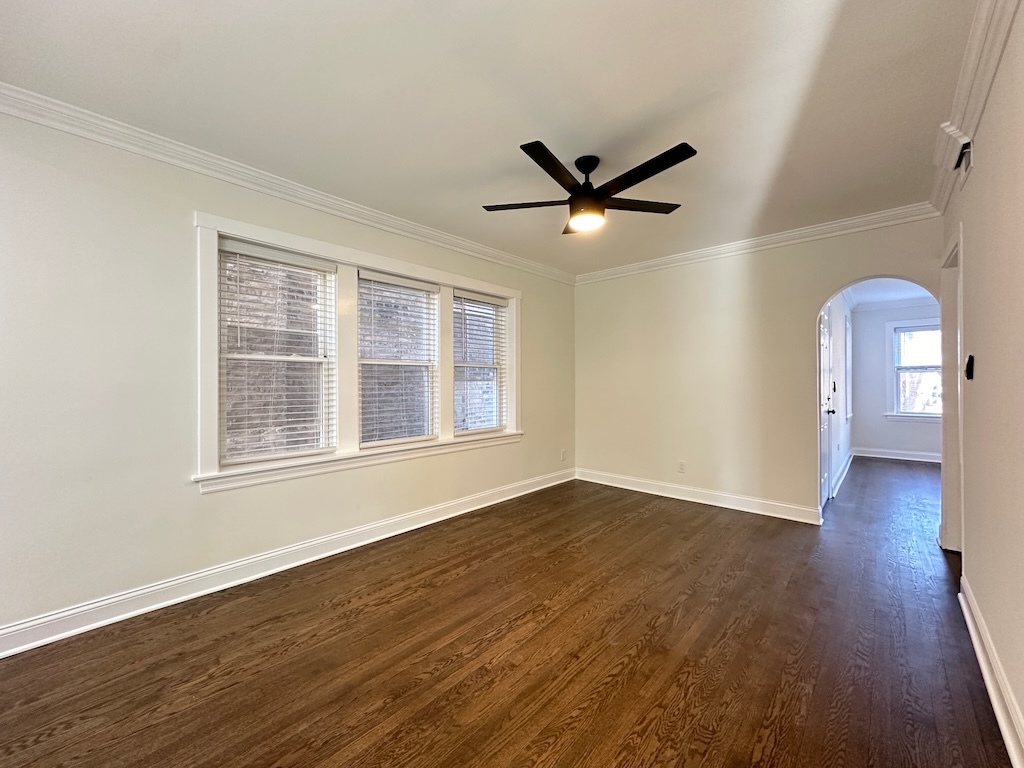 3045 West Addison Street, Unit 1 Chicago, IL 60618 - Photo 8 of 20 a view of an empty room with wooden floor and a window