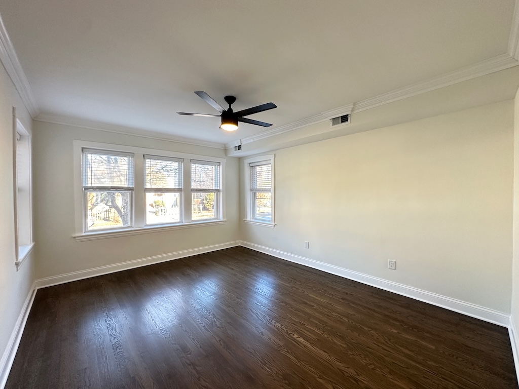 3045 West Addison Street, Unit 1 Chicago, IL 60618 - Photo 10 of 20 a view of an empty room with wooden floor and a window