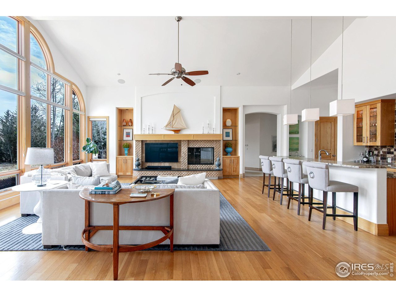 a living room with furniture a flat screen tv and a table