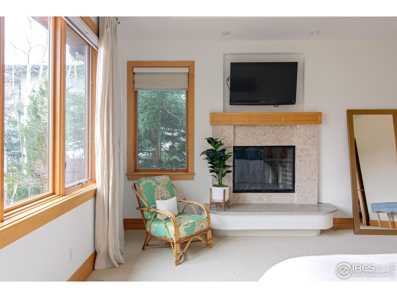 6922 Frying Pan Road Boulder, CO 80301 - Photo 14 of 39 a living room with furniture a flat screen tv and a fireplace