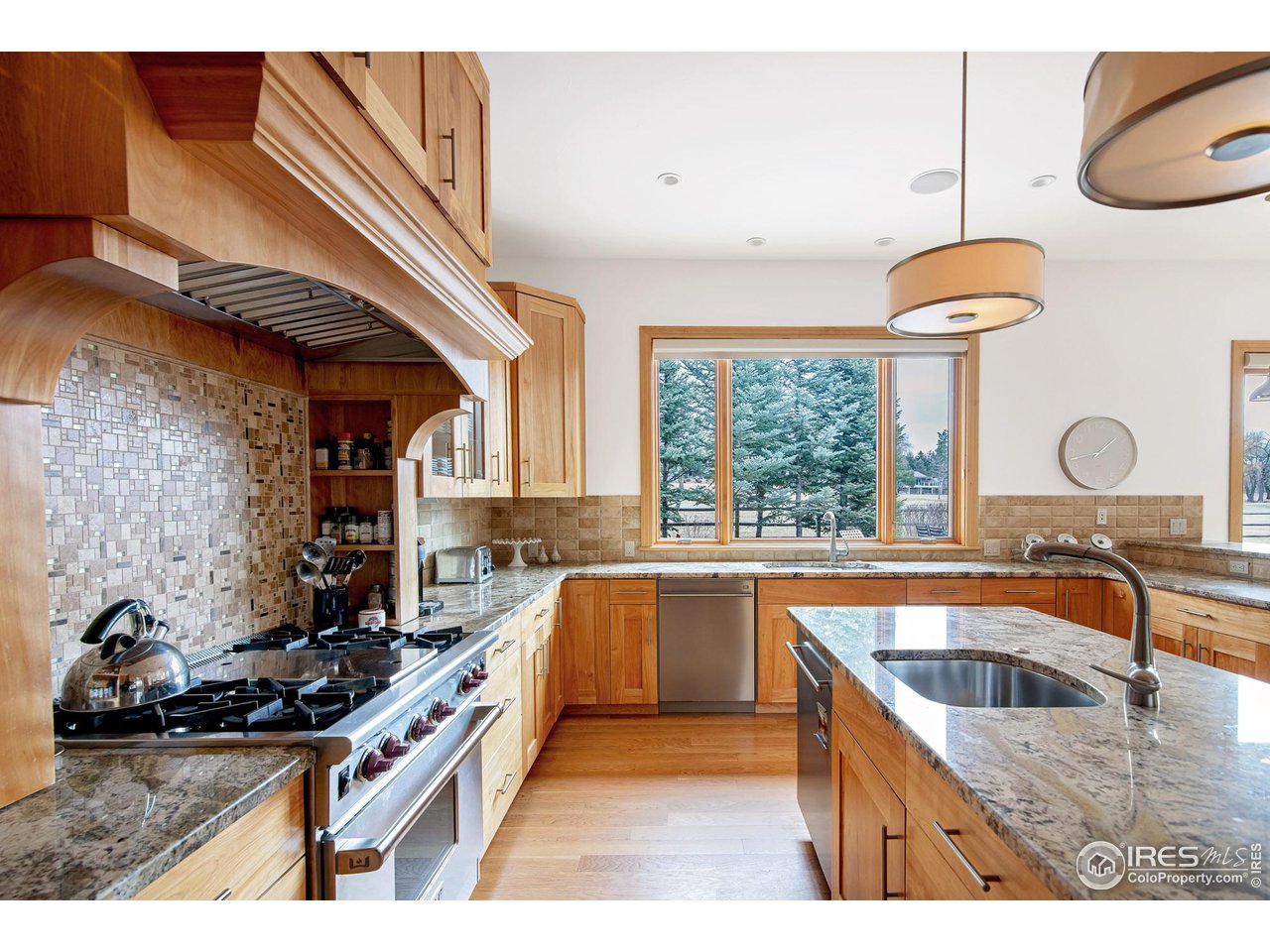 6922 Frying Pan Road Boulder, CO 80301 - Photo 21 of 39 a kitchen with stainless steel appliances granite countertop a sink a stove and a wooden floors