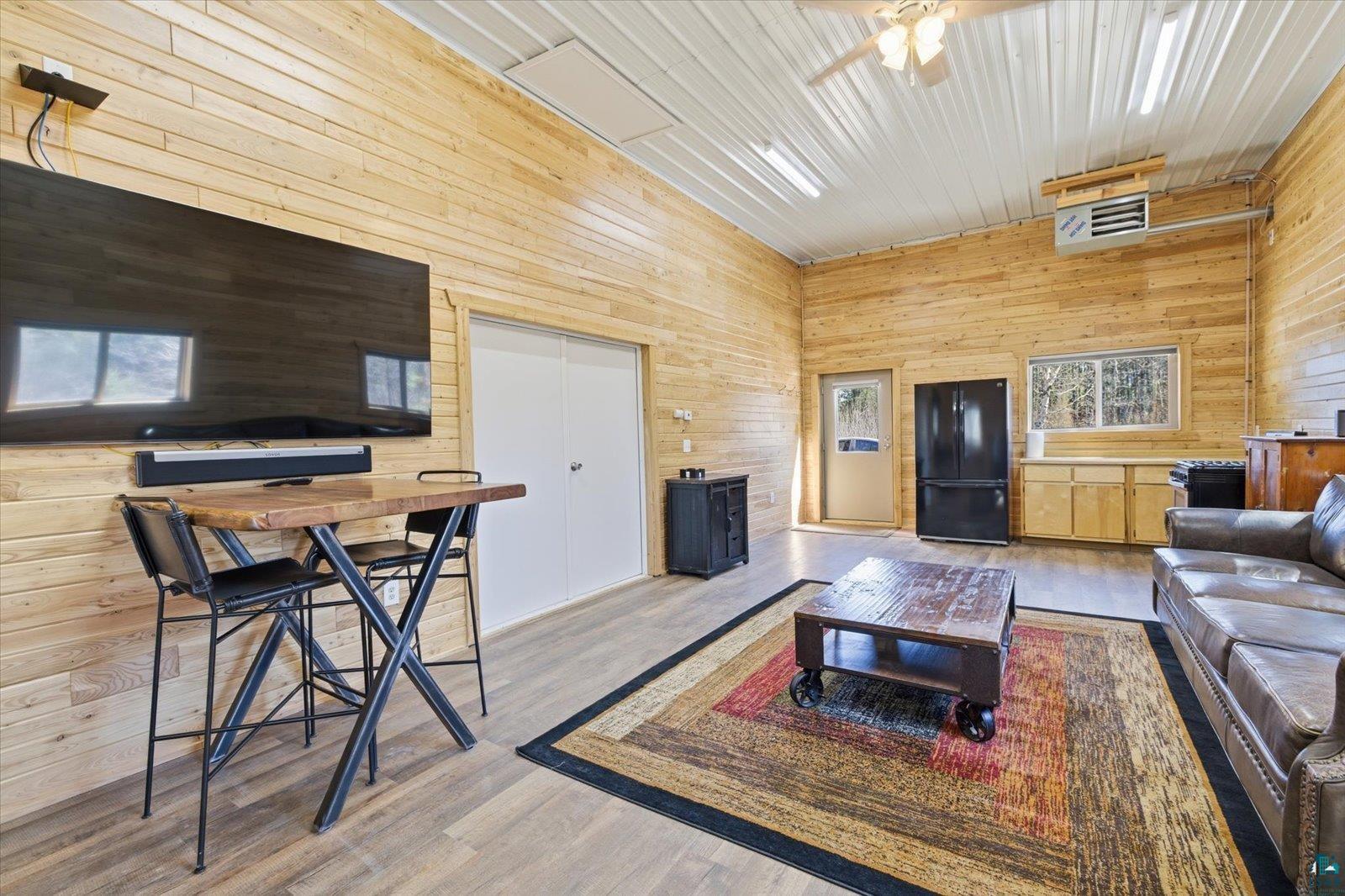 7185 Giants Ridge Road Embarrass, MN 55732 - Photo 41 of 47 Spacious interior featuring wood-finish wall paneling, vaulted ceiling with exposed beams, recessed lighting, and wood-finish flooring