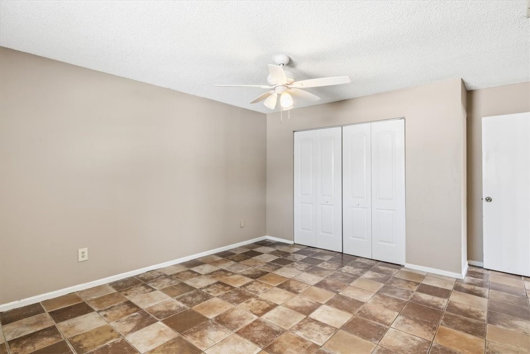 221 Balboa Street, Unit A Fort Pierce, FL 34949 - Photo 13 of 36 an empty room with a fan & a ceiling fan