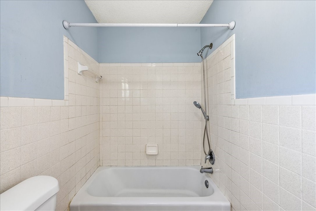 221 Balboa Street, Unit A Fort Pierce, FL 34949 - Photo 14 of 36 a bathroom with a bathtub and toilet