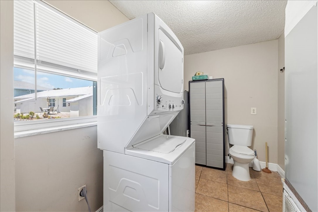 221 Balboa Street, Unit A Fort Pierce, FL 34949 - Photo 17 of 36 a bathroom with a toilet sink and mirror