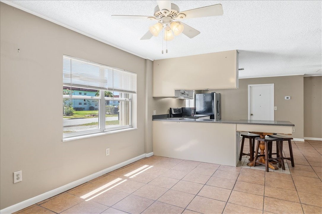 221 Balboa Street, Unit A Fort Pierce, FL 34949 - Photo 19 of 36 a kitchen with a white cabinets and chairs