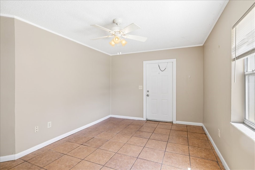 221 Balboa Street, Unit A Fort Pierce, FL 34949 - Photo 22 of 36 a view of an empty room with window and chandelier fan