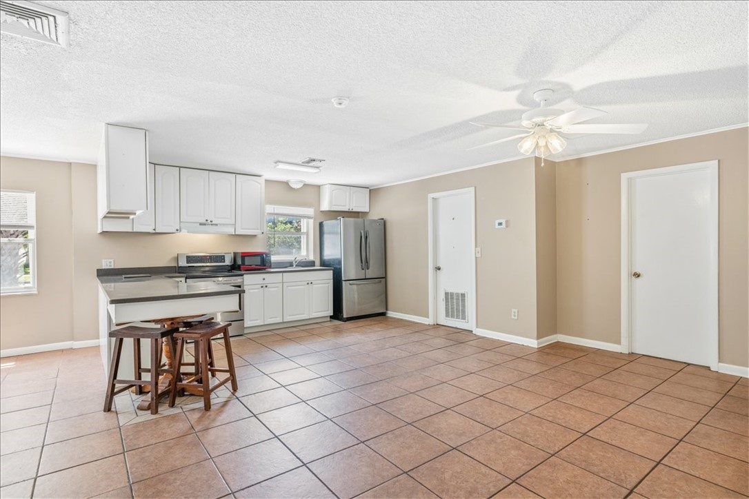 221 Balboa Street, Unit A Fort Pierce, FL 34949 - Photo 23 of 36 a kitchen with cabinets and chairs