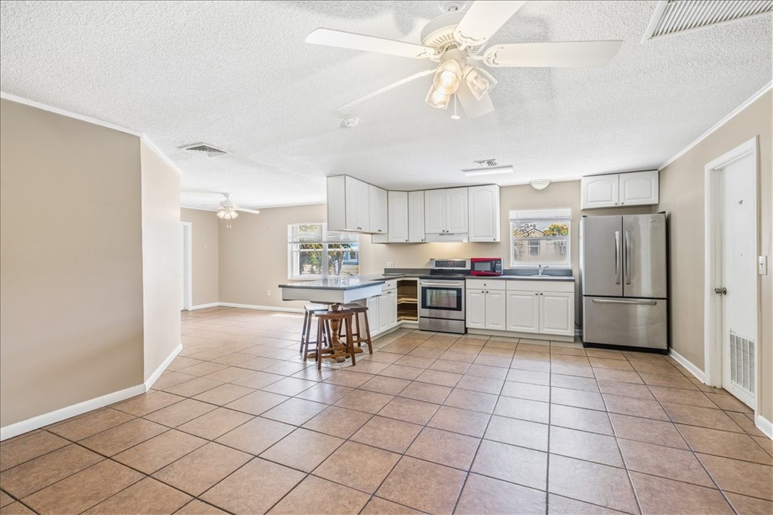 221 Balboa Street, Unit A Fort Pierce, FL 34949 - Photo 24 of 36 a kitchen with stainless steel appliances a stove a sink cabinets and a counter top space