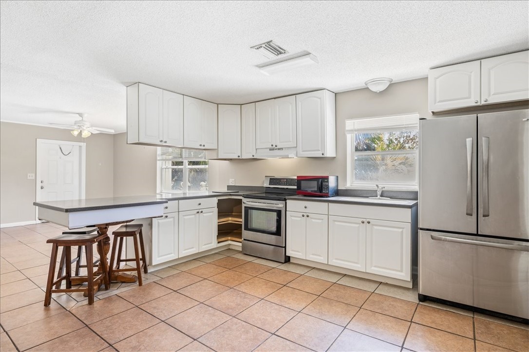 221 Balboa Street, Unit A Fort Pierce, FL 34949 - Photo 5 of 36 a kitchen with granite countertop cabinets and appliances