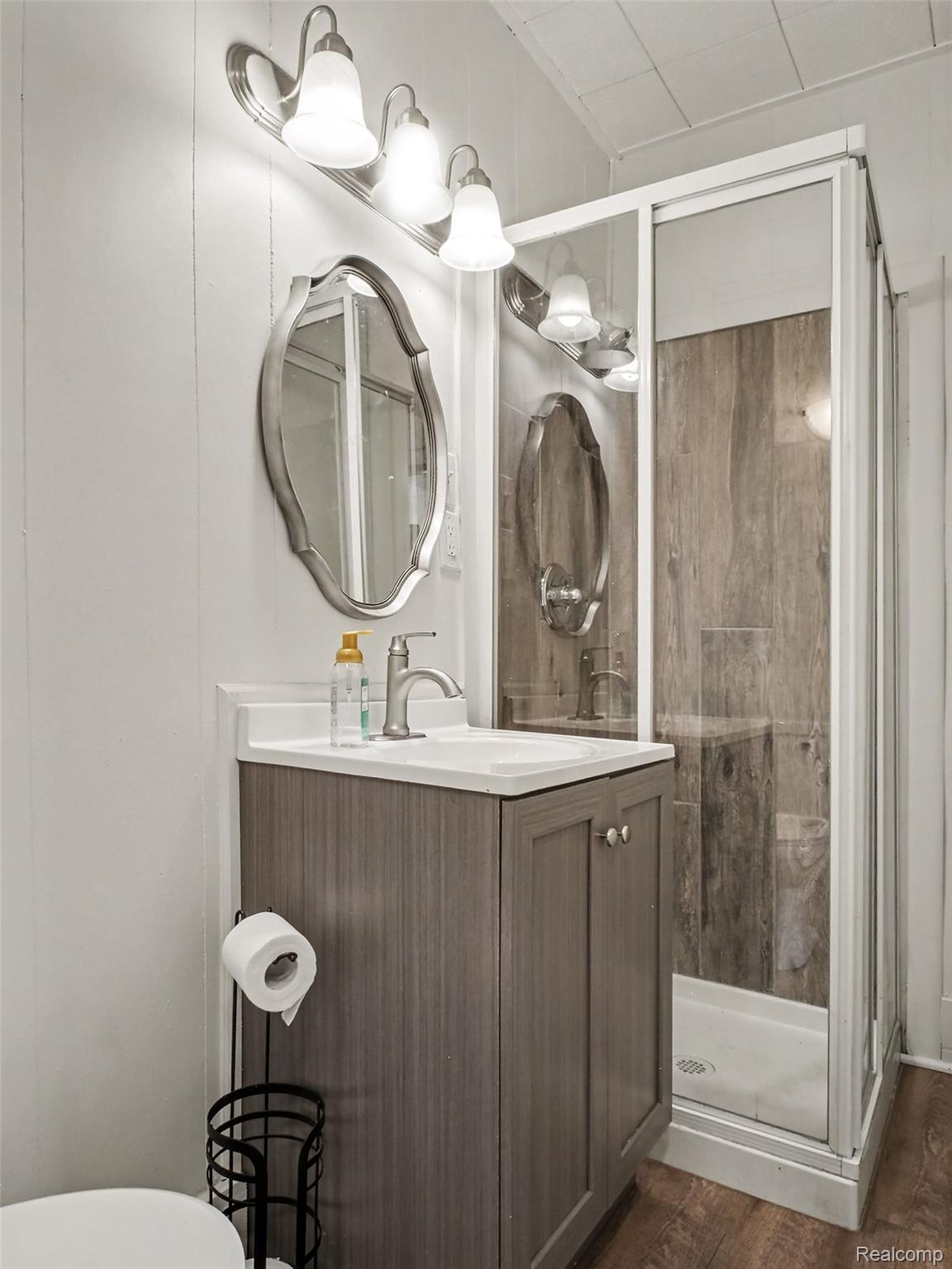 2840 Miller Road Flint, MI 48503 - Photo 22 of 49 Vanity with integrated sink, brushed nickel faucet, and overhead lighting