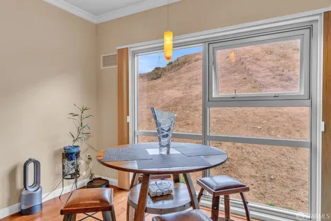 a view of a dining room with furniture window and outside view