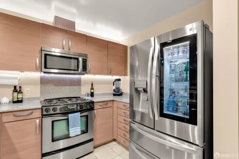a kitchen with granite countertop cabinets stainless steel appliances and a counter top space